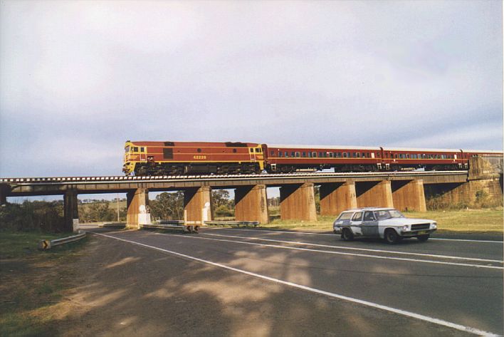 
Tuscan-coloured 42220 leads up Griffith train (SL16) off the Menangle
viaduct in the late afternoon
