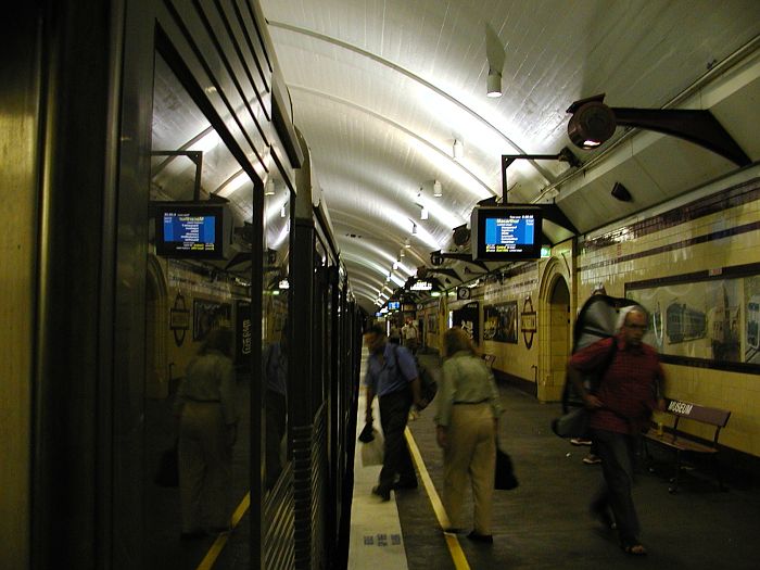 
A Tangara train has stopped on the southbound platform.  This station features
fake 1920's style advertising posters and modern destination indicators.
