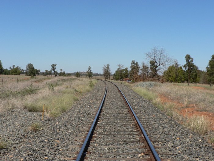 The station was on the outside of the curve in the middle distance.