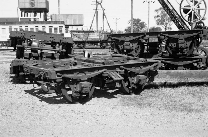 Several 2AA bogies are stacked in the yard.