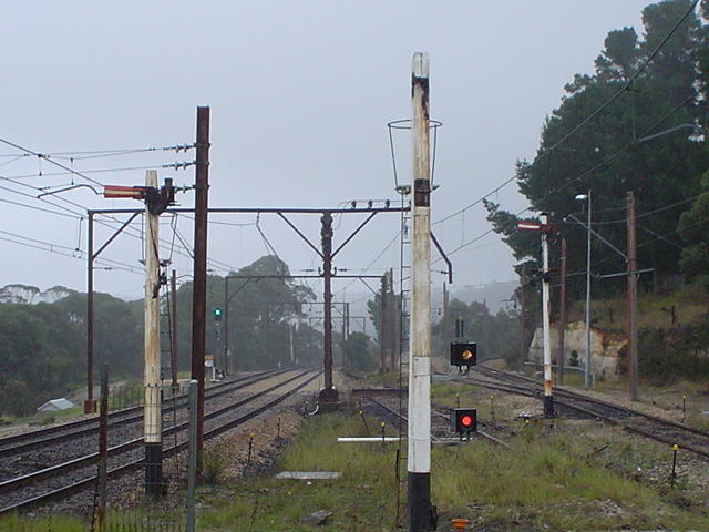 The view looking west. In recent times the refuge loop on the right has been disconnected from the main line. The signals on the post have ben removed and replaced with fixed stop lights.