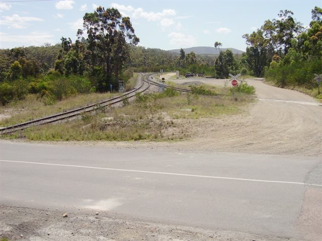 The view looking towards Newstan Colliery. This view shows the southern leg on the left, and the northern leg of the junction with main northern line just north of Fassifern Station (approx 150 metres behind the camera). The road in the foreground is a private internal route for coal trucks.