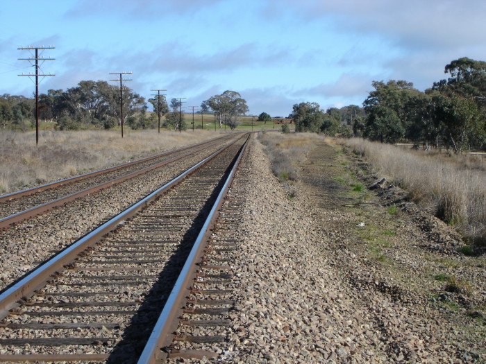The station location. The formation on the right is probably where the up main curved around behind the island platform. There was a goods siding on the opposite side of the line.