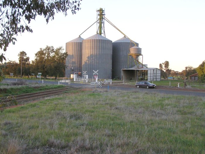 The broad gauge line heading into grain loading facility with Urana-Oaklands Road crossing in foreground.