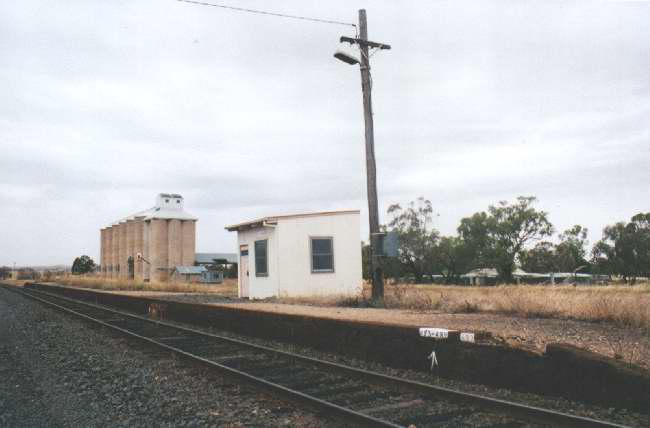 
A view of the platform with silos in the background looking towards Junee.
