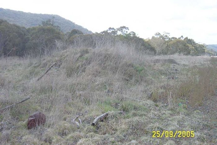 A pile of debris which may be the remains of the station from the opposite side of the line, or the goods shed.