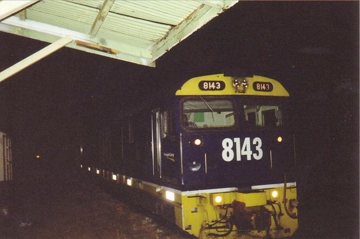 8143 heads west through the station at night.