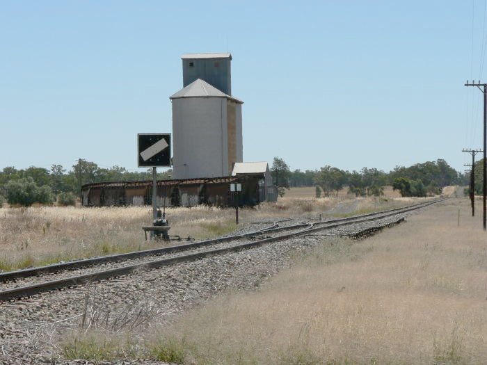 The view looking towards the silo, with a set of grain wagons in the siding.