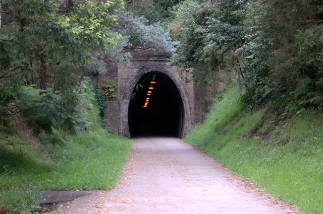 The up portal. The track bed has been converted into a rail trail, with lighting provided in the tunnel.