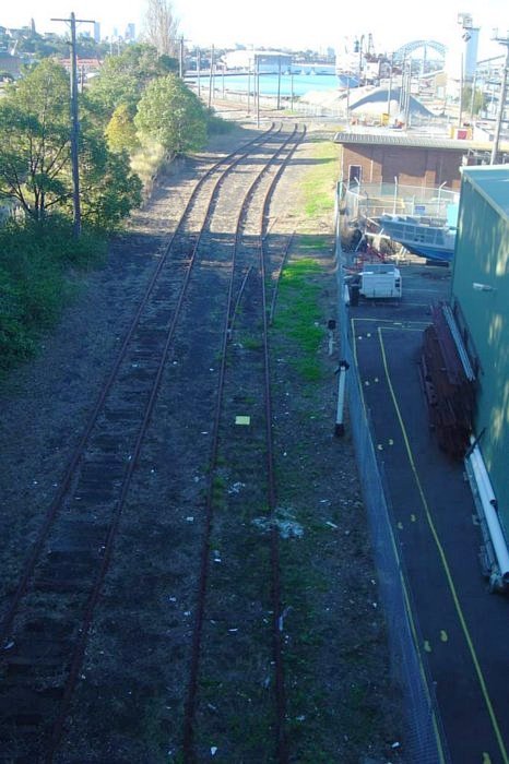 The view looking east from the Victoria Road bridge to the lines leading to White Bay. The tracks to White Bay Power Station branched off through the trees on the left.