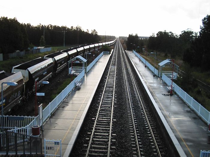 
A fully loaded coal train waits for the road on a rainy afternoon at Sandgate.
