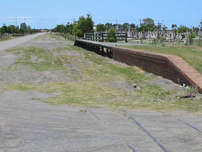 
The view of the platform looking towards the end of the line.  The remains of
the run-around siding are also visible through the grass.
