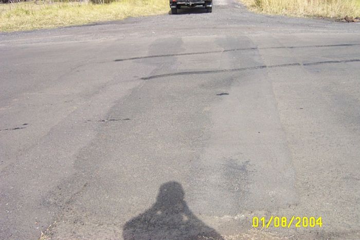 
The point where the line crossed the road is visible in the tar.
