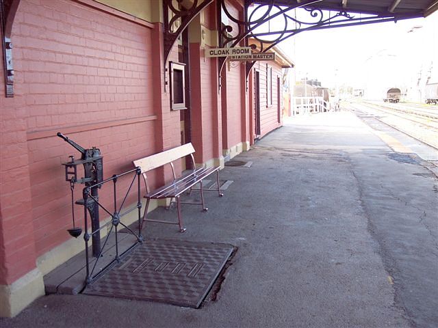 
The view along the platform looking toward Cootamundra, showing the platform
scales.  The building at the end is the signal box.
