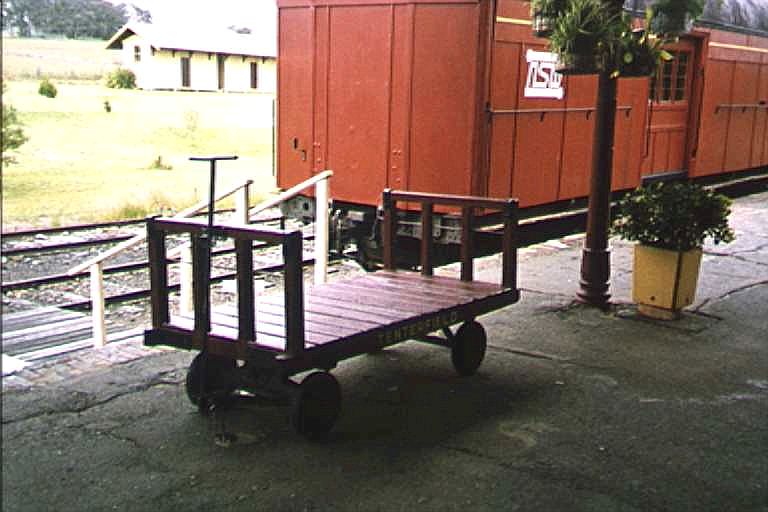 
A restored luggage trolley sits on the platform.
