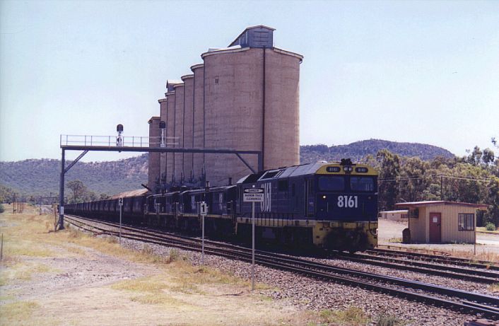 
8161 has just attached to a grain train headed by 4x48 class locos.  This
train has recently arrived off the branch line to Oaklands.
