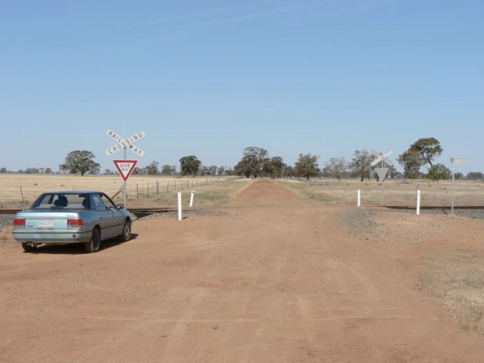 The view looking south at the level crossing at the western end of the location.