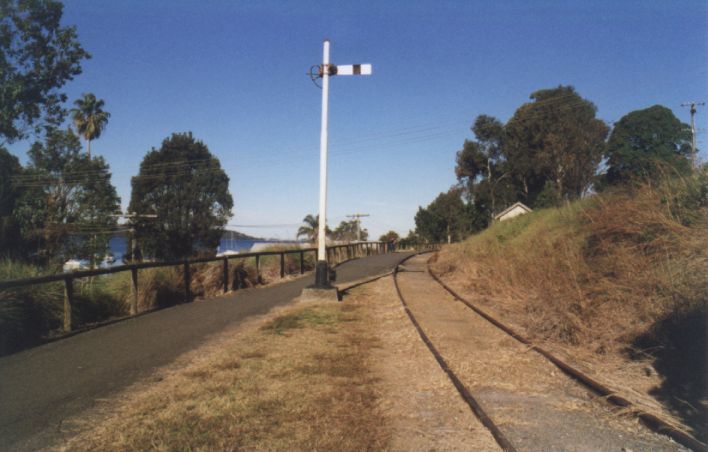 
The up home signal at the approaches to Toronto station.  Lake Macquarie
is visible between the trees on the left.
