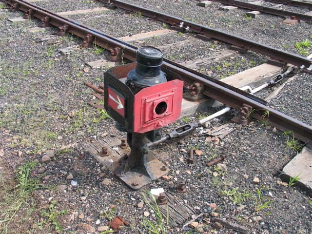 A close-up of a points indicator on a derail in the yard.