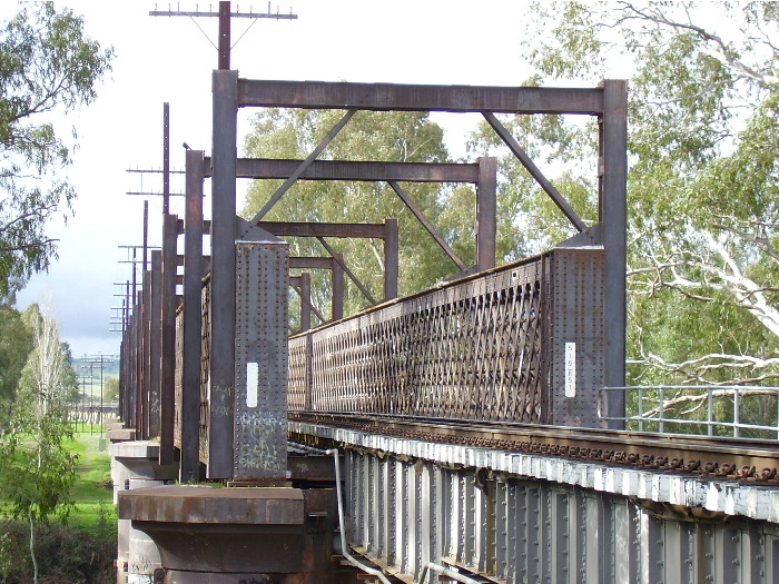 A close-up of the southern portal of the Murrumbidgee River Bridge showing the iron lattice girders and trackbed.