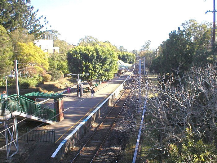 The view looking north to the Up end of platform 1 showing the access to station from road bridge.
