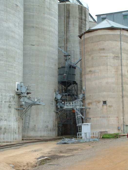 The grain silos dwarf the track and loading facilities.