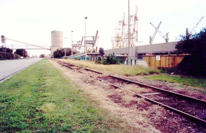 The view looking down the master siding towards the dead end. The silo in the distance is the Australian Cement Works.