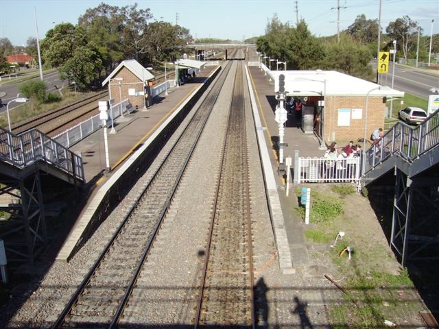 Waratah Station looking east towards Hamilton. The modern brick building on the Down platform (right hand side of photo) replaced the timber structure that was fomerly located on the footbridge from where this photo was taken. Examples of older buildings remain on the Up platform. The two tracks on the left are the Coal Roads heading to and from Port Waratah.