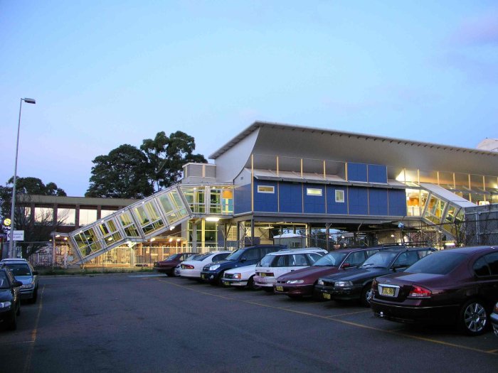 The view looking south through the car park to the modern footbridge and station area.