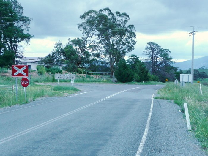 The view looking west at the level crossing, with the station location out of sight on the left.