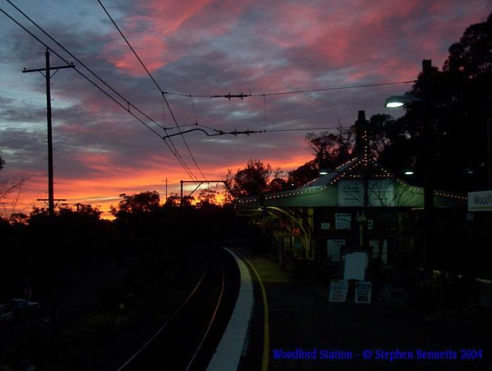 An early morning sunrise shows the station still illuminated by strings of
lights.
