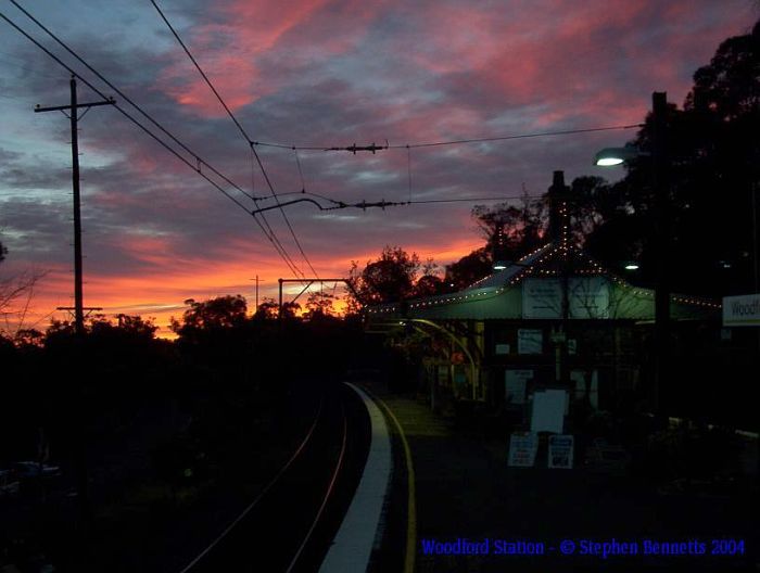 An early morning sunrise shows the station still illuminated by strings of
lights.
