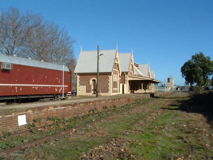 The view looking north along the platform, showing fairly overgrown track.