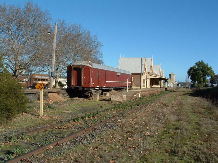 An old passenger car sits in the former dock siding at the station.