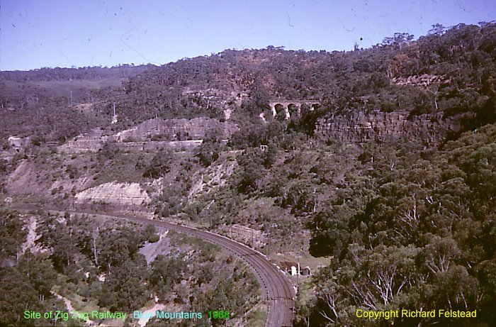 The view looking south-west towards the Zig-Zag.  The Top Road viaduct is visible in the distance, behind the cuttings for the Middle Road.  At the bottom is the main line.